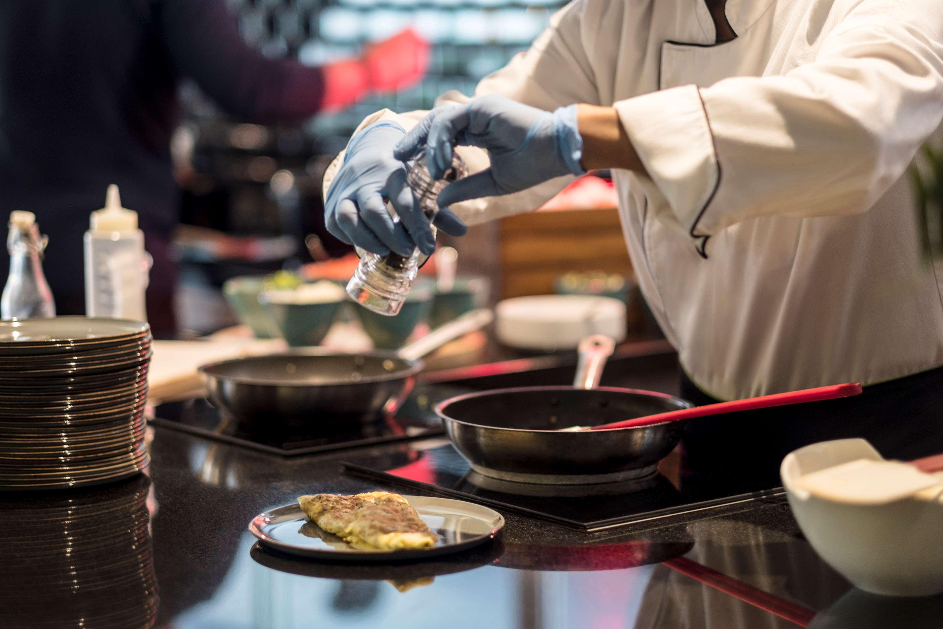 Radisson Blu Hotel, Beirut Verdun Exterior photo A chef seasoning a dish
